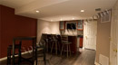 This finished basement with a wet bar in Exton, PA has a contemporary feel.