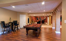 This finished basement near Collegeville, PA uses a beautiful wood laminate floor to designate the game room area.