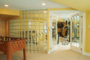This finished basement in Limerick, PA has a home gym with radius glass block wall.
