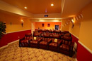 The home theater in this finished basement in the Philadelphia area is considered a Dedicated Media Room because it is completely closed off from all other spaces in the basement.